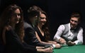 Players sitting at the playing table in the casino Royalty Free Stock Photo