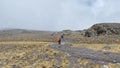 A group of porters with large backpacks and trunks on their heads are walking along a mountain path. Beautiful mountain landscape Royalty Free Stock Photo