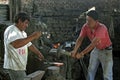 Group portrait of blacksmiths at work in smithy Royalty Free Stock Photo