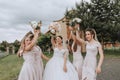 Group portrait of the bride and bridesmaids having fun. Wedding. A bride in a wedding dress and her friends in pink dresses Royalty Free Stock Photo