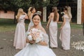 Group portrait of the bride and bridesmaids having fun. Wedding. A bride in a wedding dress and her friends in pink dresses Royalty Free Stock Photo