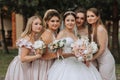 Group portrait of the bride and bridesmaids having fun. Wedding. A bride in a wedding dress and her friends in pink dresses Royalty Free Stock Photo