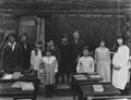 Group portrait of children standing in classroom