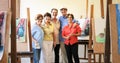 Group Portrait Of Elderly People Smiling At Art School