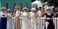 Group portrait of fashionable women in vintage dresses.