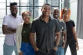 Group portrait of five african business colleagues standing in a row in office