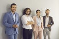 Group of happy confident successful young business people standing in studio and smiling Royalty Free Stock Photo