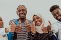 Group portrait of happy African students standing together against a white background and showing ok sign thumbs up Royalty Free Stock Photo