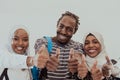 Group portrait of happy African students standing together against a white background and showing ok sign thumbs up Royalty Free Stock Photo