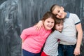 Group of kids hugging in front of chalkboard Royalty Free Stock Photo