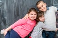 Group of kids hugging in front of chalkboard Royalty Free Stock Photo