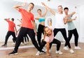 Group portrait of jolly teenagers in dance studio