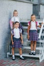 Group portrait of pre-adolescent school kids smiling in front of the school building. Back to schooll Royalty Free Stock Photo