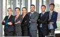 Group portrait of six business people team standing together in office with elegance manners. Idea foar teamwork in modern