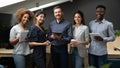 Group portrait of smiling multiethnic team posing in office Royalty Free Stock Photo