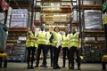 Group portrait of staff at distribution warehouse, low angle Royalty Free Stock Photo