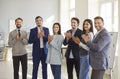 Group of smiling business professionals in office clapping and expressing support, trust and unity. Royalty Free Stock Photo