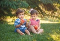 Funny children toddlers sitting together sharing apple food Royalty Free Stock Photo