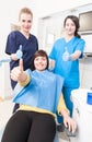 Group portrait of young doctor, assistant and patient smiling Royalty Free Stock Photo