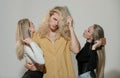 Group portrait of young people combing hair. Attractive cheerful sexy, fashionable group models combing hair Royalty Free Stock Photo