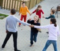 Group of positive children playing red rover