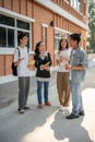 Group of positive diverse Asian college student friends are talking after classes in their campus Royalty Free Stock Photo