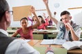 Group of happy school pupils raise their hands up Royalty Free Stock Photo