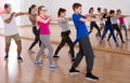 Group of positive smiling teenagers dancing in classroom Royalty Free Stock Photo