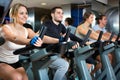 Group positive working out of cycling in fitness club