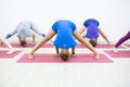 Group of positivel people practicing yoga in gym