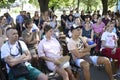 Group of pregnant women and their husbands sitting on chairs and listening to in the park. June 25, 2019. Kiev, Ukraine