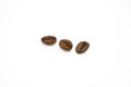 Group of premium dark-roasted coffee beans isolated on a white background. Royalty Free Stock Photo