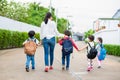 Group of preschool student and teacher holding hands and walking to home. Mom bring her children go to school together. Back to Royalty Free Stock Photo