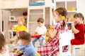 Group of preschooler children playing with musical toys at kindergarten