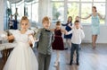 Group of preteen children movements of waltz in dance studio Royalty Free Stock Photo