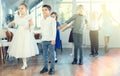 Group of preteen children movements of waltz in dance studio Royalty Free Stock Photo