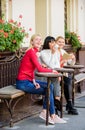 Group pretty women terrace entertain themselves with reading and listening. Coffee cafe. Way to relax and recharge