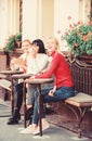 Group pretty women terrace entertain themselves with reading and listening. Coffee cafe. Way to relax and recharge