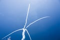 A group of professional pilots of military aircraft of fighters on a sunny clear day shows tricks in the blue sky, leaving beauti Royalty Free Stock Photo