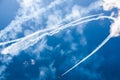 A group of professional pilots of military aircraft of fighters on a sunny clear day shows tricks in the blue sky, leaving beauti Royalty Free Stock Photo