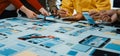 Collaborative Teamwork on Website Design Project with Prototypes and Wireframes Displayed on Table during Creative Royalty Free Stock Photo