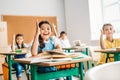 group of pupils raising hands to answer question Royalty Free Stock Photo