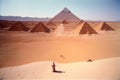 A Group Of Pyramids Sitting In The Middle Of A Desert. Generative AI