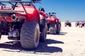 A group of quad bikes drive in the desert