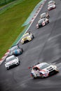 Group of racing touring cars challenging during the race at turn