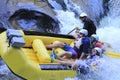 A group rafting down raging rapids