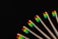 Group of rainbow eco bamboo toothbrushes, on black background. Royalty Free Stock Photo