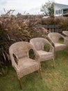 The group of rattan chairs in the garden near the terrace of the local restaurant
