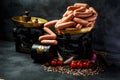 group of raw long thin wieners on antiquarian scales Royalty Free Stock Photo