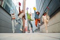 Group of real teenage students having fun jumping up at university campus. Young adult multiracial friends leaping at Royalty Free Stock Photo